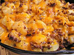 a casserole dish with potatoes, meat and cheese