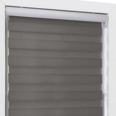 an open window with blinds that are closed and the blinds have been made from grey fabric