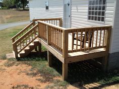 a wooden porch with steps leading up to a house