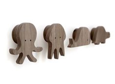 three wooden elephants standing next to each other on a white background with the words art - set merestie written below them