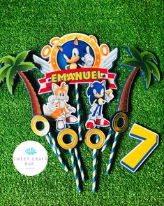 sonic the hedgehog birthday cake topper and decorations on green grass with stickers