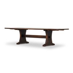 an old wooden table with two legs and a long slab on one end, against a white background