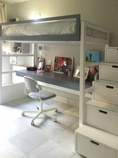 a white loft bed sitting next to a desk with drawers and a book shelf on top of it