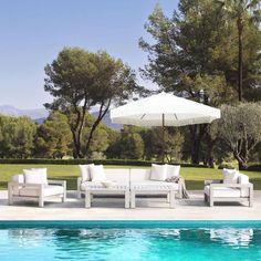 an outdoor lounge set next to a swimming pool