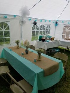 a tent with tables and chairs set up for an event