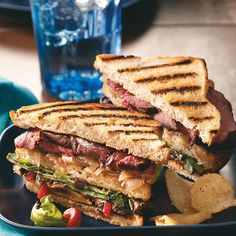 a grilled sandwich on toasted bread with lettuce and tomato wedges