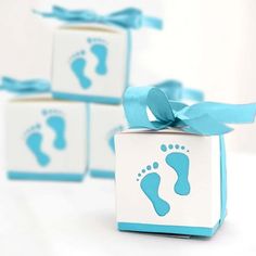 three boxes with baby footprints and blue ribbon tied around them