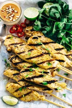 grilled chicken skewers with cilantro sauce and fresh herbs on the side