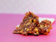 two pieces of food sitting on top of a white plate next to a pink table