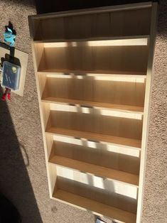 an empty book shelf sitting on the side of a building