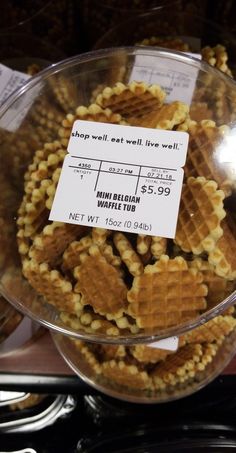 some waffles are in a bowl on the counter with price tags attached to them