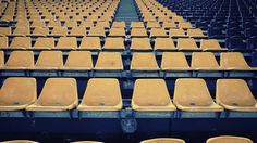 rows of empty seats in an empty stadium