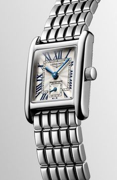 Inspired by the Italian 'sweet life,' this Swiss watch comes in a slender rectangle shape that's based on models from the 1920s. Its set on a polished bracelet and features graceful tapered indexes and a second subdial for minimalist style. 29mm x 21.5mm case Deployant clasp closure Swiss quartz movement Sub-eye second hand Guilloche dial Sapphire crystal face Stainless steel Swiss made Elegant Silver Watch With Square Face, Classic Rectangular Watches With Date Display, Timeless Rectangular Watch With Date Display, Classic Silver Watch Accessories With Rectangular Dial, Classic Silver Rectangular Watch Accessories, Classic White Gold Rectangular Watch Accessories, Classic Rectangular White Gold Watch Accessories, Silver Rectangular Watch With Subdials, Silver Rectangular Watch Accessories With Polished Finish