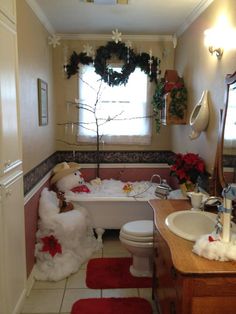 a bathroom decorated for christmas with teddy bears