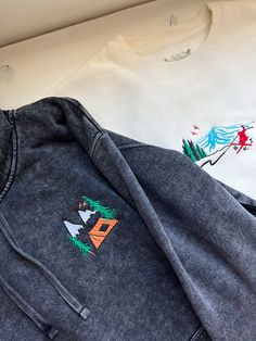 We sell primarily on our website where we offer  free shipping options. TwinRavenCo. See our website for a long-sleeve option as well.  This hoodie features a retro mountain camping vibe - perfect for any wintery adventure.  𓄿 Mineral Washed giving that perfect weathered look 𓄿 Unisex 𓄿 Split stitch double needle sewing on all seams 𓄿 Jersey lined hood 𓄿 1 x 1 ribbing at cuffs and waistband 𓄿 The embroidered design uses thread made from the highest quality, recycled materials 𓄿 Designed and embroidered in our studio in Canada * Check out our socials for discounts, new releases, and to see how we run our shop: TwinRavenCo Embroidery stabilizer is applied to the back of every embroidered item and is never to be removed. It is there to keep the stitches stable over time. This stabilize Cotton Hoodie For Outdoor, Outdoor Long Sleeve Cotton Hoodie, Cotton Long Sleeve Hoodie For Outdoor, Outdoor Long Sleeve Cotton Sweatshirt, Cotton Hoodie With Embroidered Graphics, Hooded Winter Sweatshirt With Embroidered Graphics, Embroidered Long Sleeve Hoodie For Streetwear, Winter Hooded Sweatshirt With Embroidered Graphics, Winter Long Sleeve Hoodie With Embroidered Logo