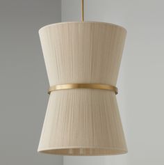 a beige lamp shade hanging from a ceiling