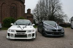 two cars parked next to each other in front of a building