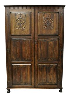 an old wooden armoire with carvings on the front and sides, isolated against a white background