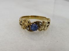 BEAUTIFUL ESTATE 14K YELLOW GOLD SAPPHIRE AND DIAMOND BAND RING. SIZE 6.5. GREAT SHAPE. 3.3 GRAMS. 6.6MM WIDE. UNMARKED ACID TESTS FOR 14K. 4.3MM CAB SAPPHIRE TWO SMALL DIAMONDS. WILL COME IN NICE RING BOX.PLEASE BE ADVISED SOME PHOTOS ARE CLOSEUPS TO SHOW DETAIL, PLEASE READ FULL DESCRIPTION FOR BETTER UNDERSTANDING OF SIZE.  This item is preloved and Antique/Vintage. This means it may have signs of wear and use and is offered as is.  You will receive the exact item shown in the photos. There m Victorian Yellow Gold Sapphire Ring Stamped 14k, Heirloom Yellow Gold Sapphire Ring Collectible, Gold Multi-stone Sapphire Ring For Anniversary, Victorian Gold Sapphire Ring Stamped 14k, Victorian 14k Gold Stamped Sapphire Ring, Vintage Rings Antiques, Antique Sapphire Engagement Rings, Daisy Engagement Ring, Quirky Ring