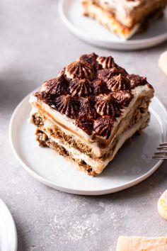 a piece of cake sitting on top of a white plate next to crackers and a fork