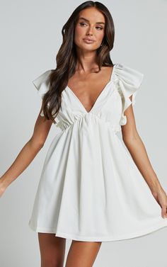 Raiza Mini Dress - Ruffle Sleeve Tie Back Plunge Dress in Off White Classy Graduation Outfit, White Grad Dress, Rush Week Outfits, Bride Reception Dresses, Confirmation Dresses, White Dresses Graduation, Senior Stuff, Dresses Graduation, White Ruffle Dress