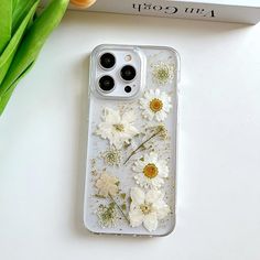 an iphone case with white flowers on it