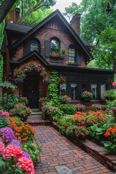 a house with lots of flowers in the front yard and walkway leading up to it