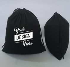 two black drawsack bags with white lettering on the front and back, sitting side by side