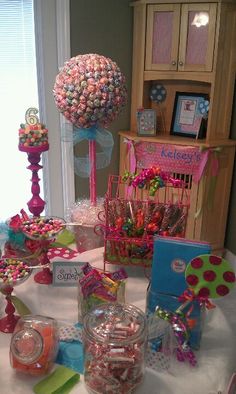 a table topped with lots of candy and lollipops on top of it