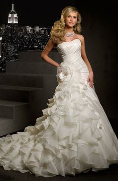 a woman in a wedding dress standing on stairs