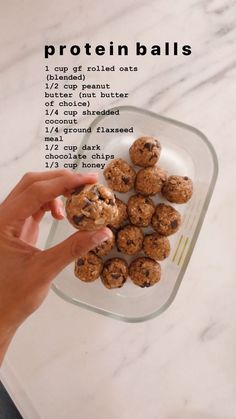 a hand holding a cookie doughnut in front of a plate with chocolate chip cookies on it