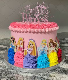 there is a birthday cake with princesses on it