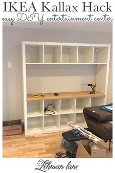 a living room with hard wood floors and white bookcases