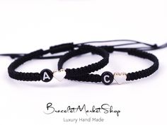 two black and white bracelets with hearts on them