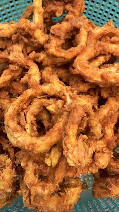 fried onion rings on a blue plate