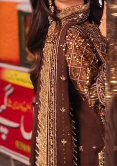 Introducing our new collection 'CHAMKEELI' by Asim Jofa designed to make you look and feel your best. Embrace the warmth of autumn in this festive earth-toned creation. The embroidered shirt unfurls like a weathered landscape, its intricate design a tapestry woven from threads of desert gold. Gold zari shimmers like sunlight dancing on windswept dunes, while scattered 5mm gold sequins, like desert wildflowers peeking through parched earth, add a touch of unexpected beauty. Paired with an airy du Traditional Dresses With Resham Embroidery For Fall, Traditional Festive Winter Dresses, Traditional Winter Festive Dresses, Brown Fall Wedding Dress, Traditional Brown Dresses For Festivals, Brown Wedding Dress With Intricate Embroidery, Brown Wedding Dress For Eid, Festive Dresses With Embroidered Sleeves For Festivals, Festive Dresses With Embroidered Sleeves