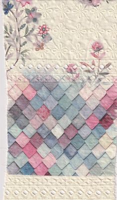 a piece of fabric with flowers and leaves on the side, in pastel colors