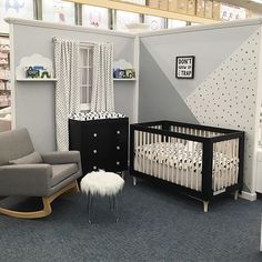 a baby's room is decorated in gray and white