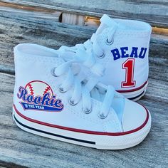 a pair of white high top sneakers with the name beau 1 on each side