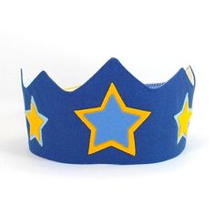 a blue and yellow crown with stars on the front, sitting on a white surface