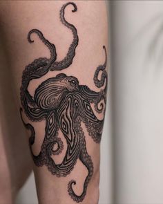 an octopus tattoo on the leg of a woman