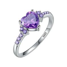 a heart shaped amethorate ring with purple stones on the sides and white gold band