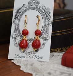 These lovely and lively earrings are made with a combination of acrylic and shell pearl stones in a beautiful, rich red tone. These versatile earrings work well for many historical eras, especially the Italian Renaissance, Regency, and Victorian eras. These measure about 1.5" long in total and are available as hoops (shown), lever, or clip-on styles. Elegant Red Teardrop Earrings With Ear Wire, Handmade Red Earrings For Formal Occasions, Red Pearl Drop Earrings For Wedding, Traditional Red Pearl Drop Earrings, Elegant Red Teardrop Chandelier Earrings, Elegant Red Pearl Drop Jewelry, Red Pearl Drop Earrings For Formal Occasions, Traditional Red Pearl Earrings For Formal Occasions, Handmade Elegant Baroque Earrings