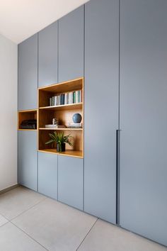 an empty room with some bookshelves and shelves on the wall next to each other