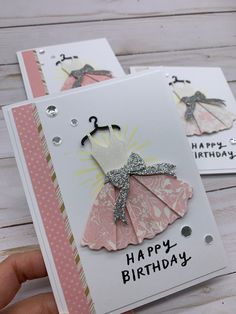 two handmade birthday cards, one with a dress on it