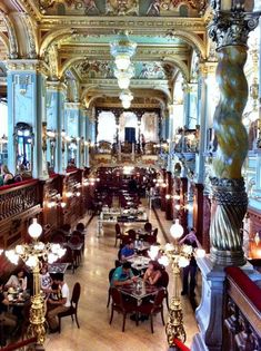 an ornately decorated restaurant with chandeliers and tables