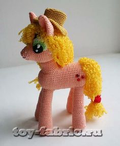 a crocheted pink pony with yellow mane