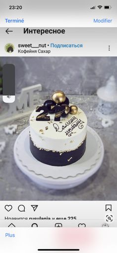 a cake that is sitting on top of a white plate with black and gold decorations