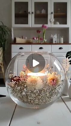 a vase filled with flowers sitting on top of a table