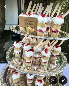 desserts are arranged on three tiered trays